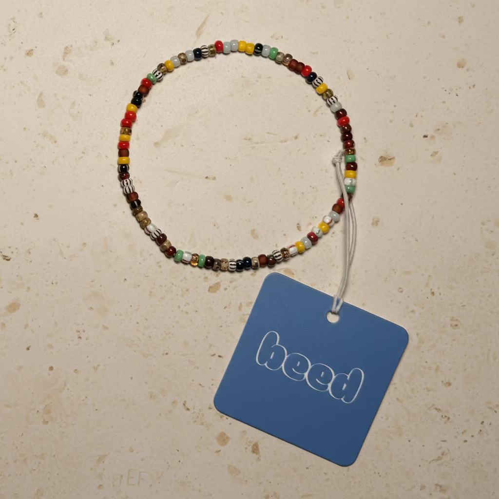 The Mia beaded bracelet with blue beed tag on a beige background