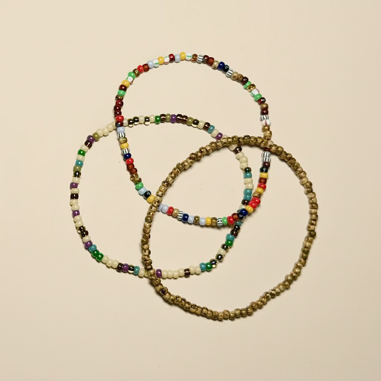beed bracelets stacked on a white surface